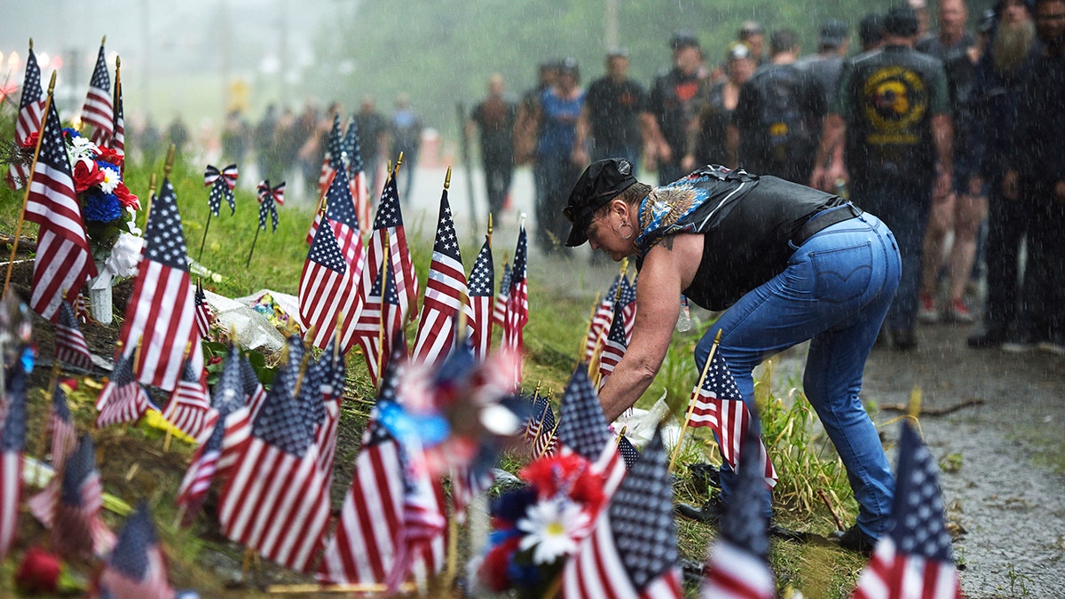 Bikers at the memorial site where seven bikers riding with the Jarheads Motorcycle Club were killed in a collision last month Saturday. (Paul Hayes/Caledonian-Record via AP)