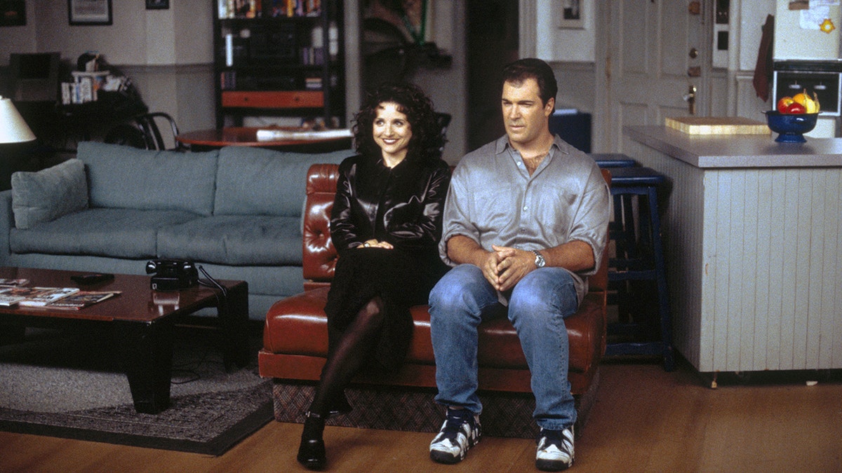 SEINFELD -- 'The Burning' Episode 16 -- Julia Louis-Dreyfus as Elaine Benes, Patrick Warburton as David Puddy.