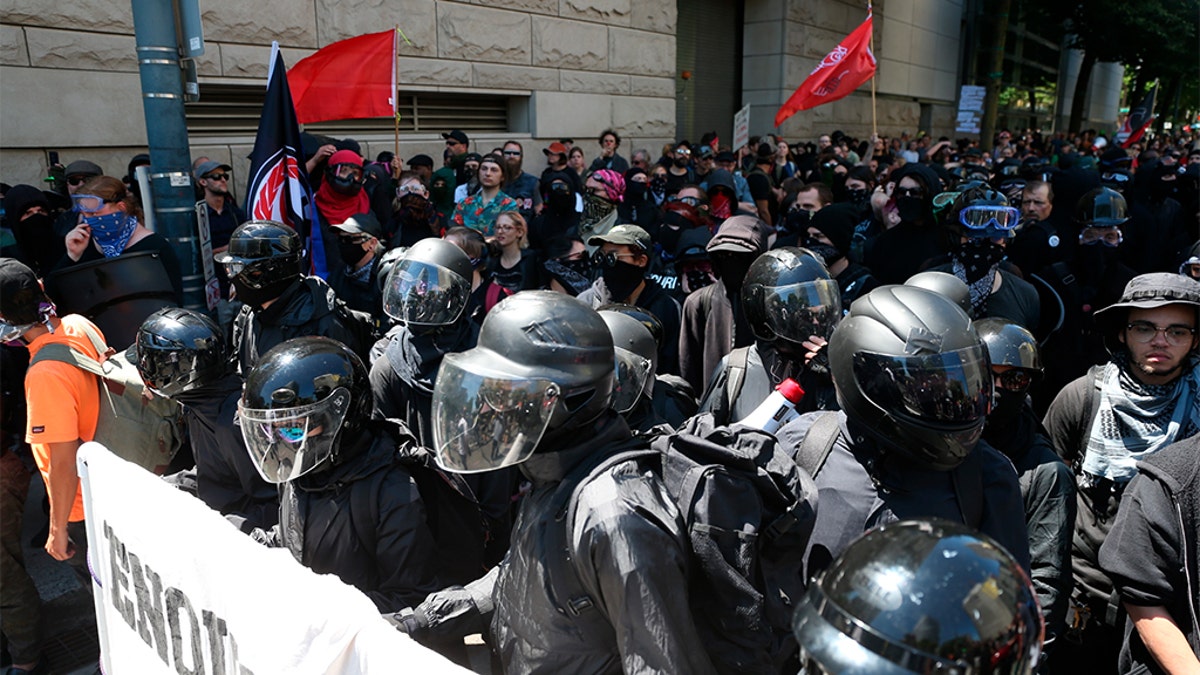 Multiple groups, including Rose City Antifa, the Proud Boys and conservative activist Haley Adams protest in downtown Portland, Ore., Saturday, June 29, 2019. (Dave Killen/The Oregonian via AP)