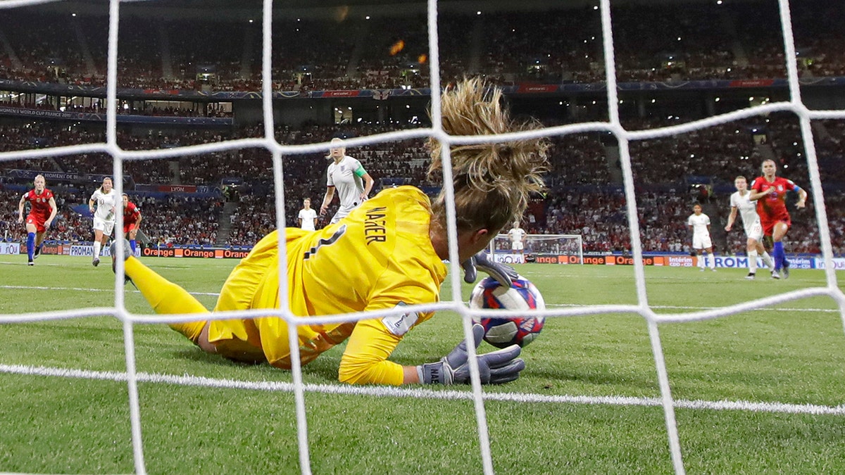 United States goalkeeper Alyssa Naeher saves a penalty shot taken by England's Steph Houghton during the Women's World Cup semifinal soccer match between England and the United States, at the Stade de Lyon, outside Lyon, France, Tuesday, July 2, 2019. (AP Photo/Alessandra Tarantino)