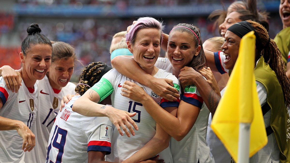 United States' Megan Rapinoe, center, celebrates after scoring the opening goal from the penalty spot during the Women's World Cup final soccer match between US and The Netherlands at the Stade de Lyon in Decines, outside Lyon, France, Sunday, July 7, 2019. (AP Photo/Francisco Seco)