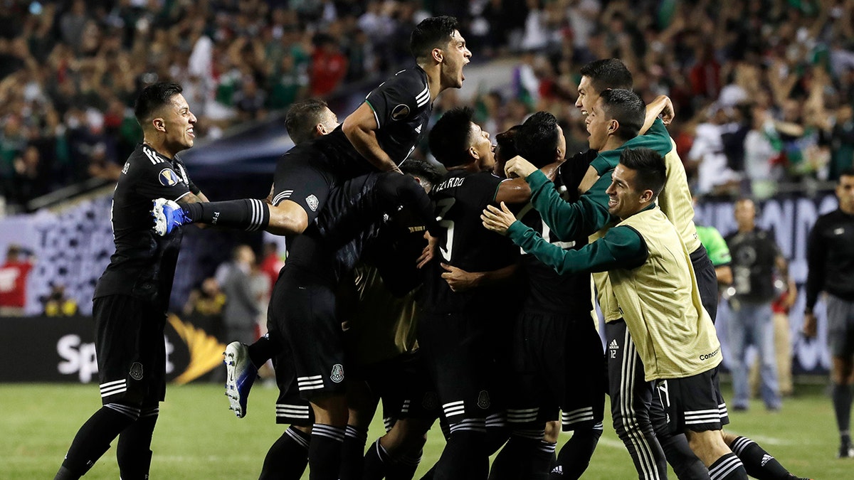 Mexico midfielder Jonathan Dos Santos (6) celebrates with teammates after scoring his first goal against the United States during the second half of the CONCACAF Gold Cup final soccer match in Chicago, Sunday, July 7, 2019. (AP Photo/Nam Y. Huh)