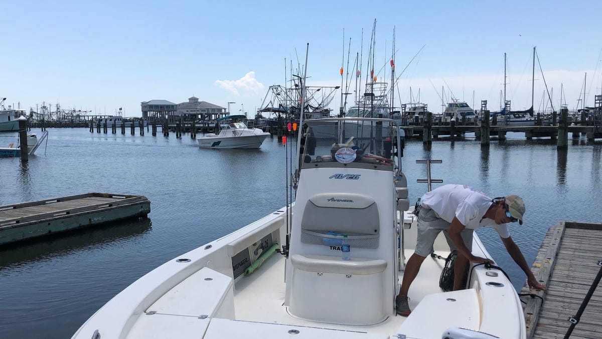 Sonny Schindler, owner and guide for Shore Thing Fishing Charters, ties his boat up to a dock. He said he's had to work harder to hold onto his customers after the emergence of the toxic algae blooms. (Fox News/ Charles Watson)