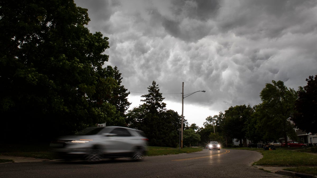 A storm bringing strong winds and a drop in temperature moves in over Flint, Mich., on Saturday, July 20, 2019.