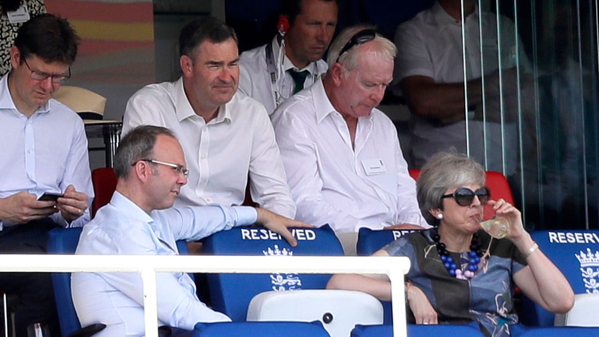 Britain's former Prime Minister Theresa May, bottom right, watches from the stands during the second day of the test match between England and Ireland at Lord's cricket ground in London, Thursday, July 25, 2019. (AP Photo/Kirsty Wigglesworth)