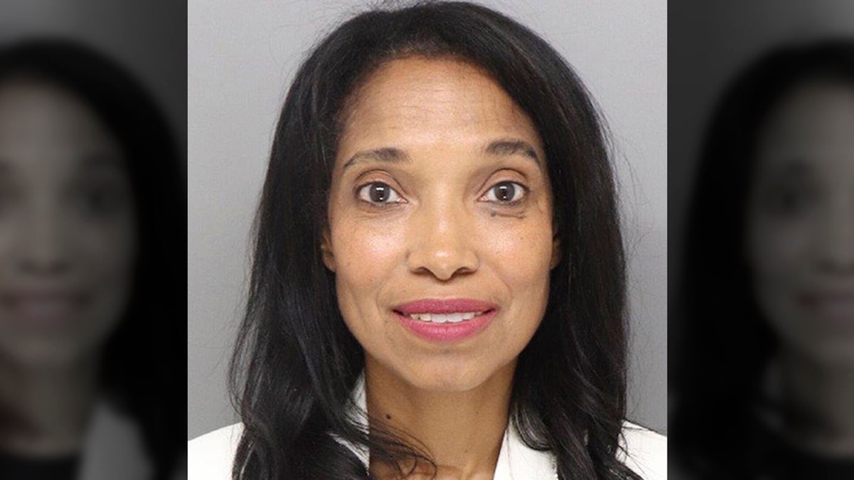 A deputy with her arms under the defendant’s shoulders pulled Tracie Hunter across the courtroom after she went limp. Supporters stood and yelled in anger, and deputies intercepted a woman who tried to rush to her. (Hamilton County Jail via AP)