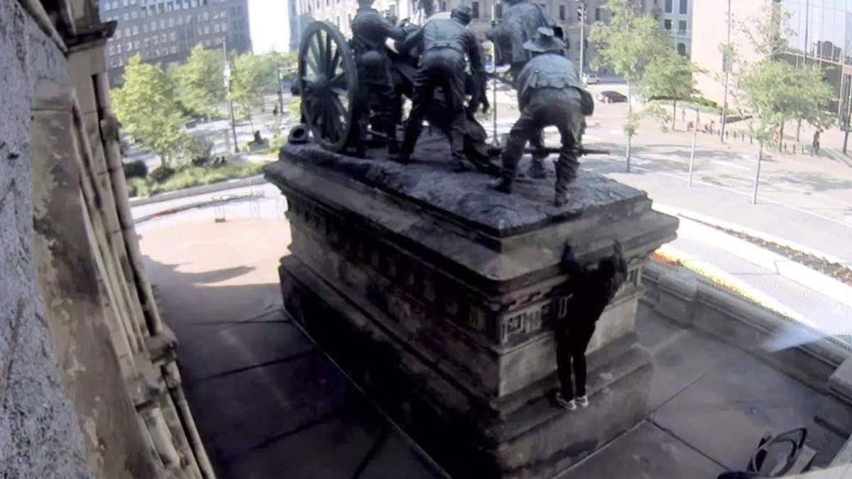 A suspect is seen climbing the Soldiers' and Sailors' Monument in Cleveland on Wednesday evening. (Surveillance video)