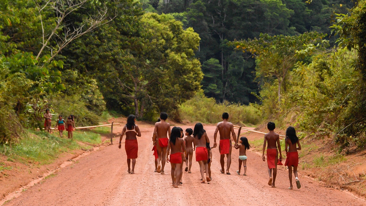 Brazilian Waiapi walk on the road of the Waiapi indigenous reserve, at Pinoty village in Amapa state in Brazil on October 12, 2017. (APU GOMES/AFP/Getty Images)