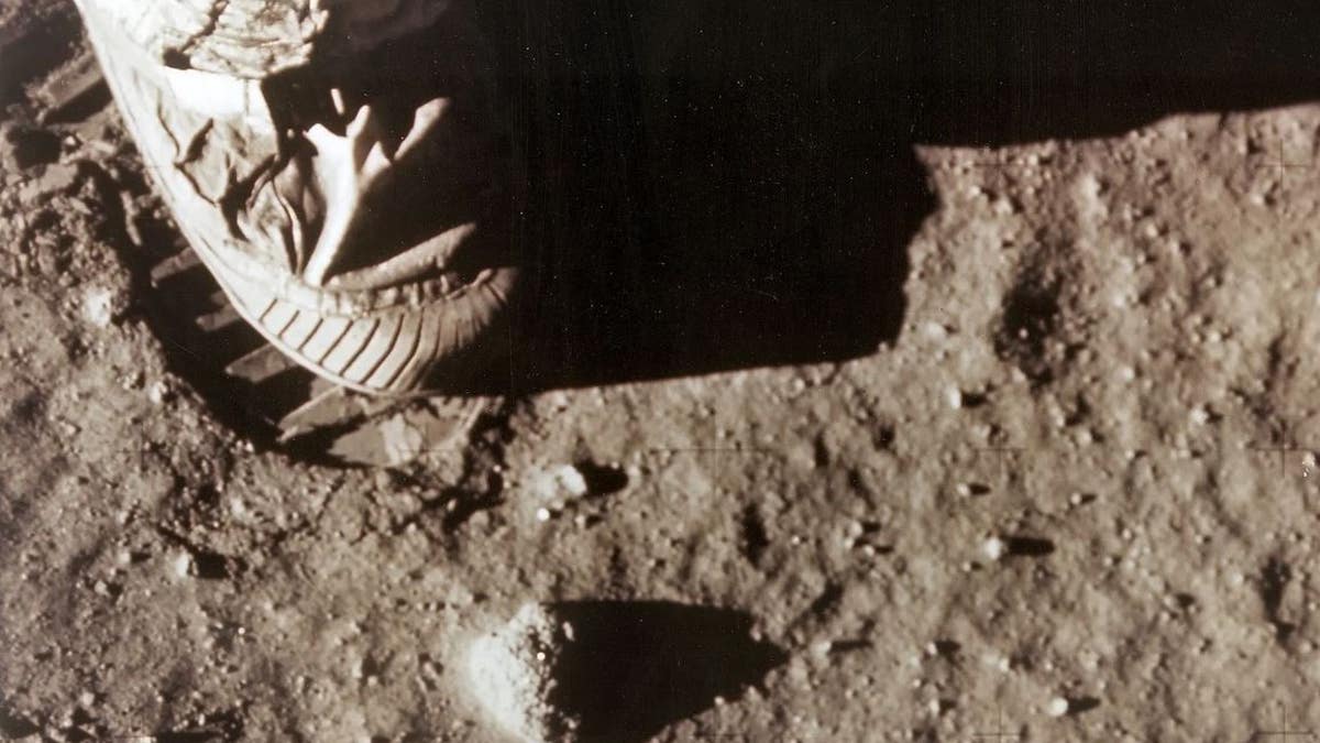 Astronaut Neil Armstrong's right foot leaves a footprint in lunar soil