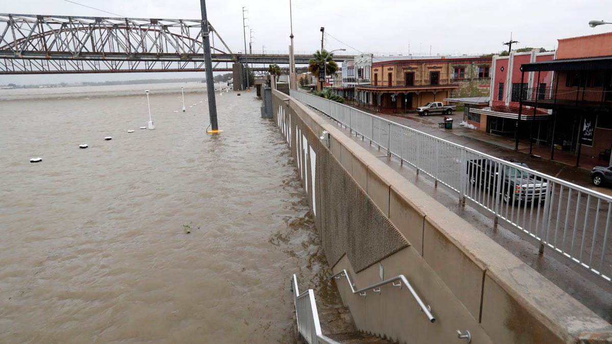 As the Atchafalaya River continues to rise due to the rains of Tropical Storm Barry, it becomes harder to see the Morgan City name on the sea wall, Saturday, July 13, 2019, in Morgan City, La.