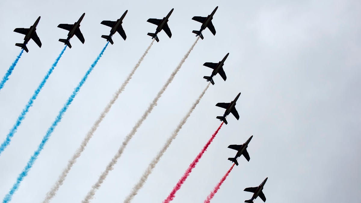 French Alpha jets of the Patrouille de France spray lines of smoke in the colors of the French flag over the Champs-Elysees during Bastille Day parade Sunday, July 14, 2019, near the Champs Elysees avenue in Paris.