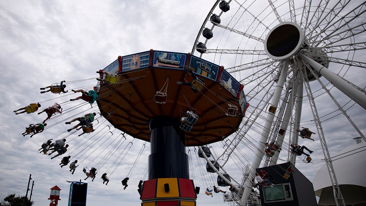 People ride a wave swinger at Chicago's Navy Pier, Friday, June 21, 2019. (Associated Press)