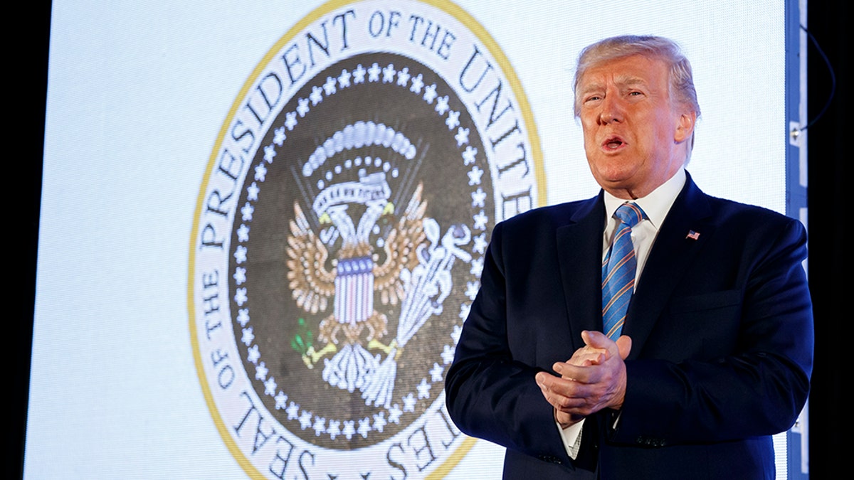 President Trump arrives to speak, with an altered presidential seal behind him, at Turning Point USA's Teen Student Action Summit 2019, Tuesday, July 23, 2019, in Washington. (AP Photo/Alex Brandon)