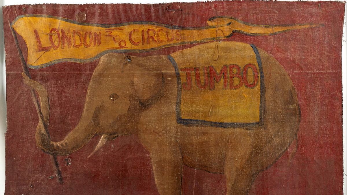 The cloth canvas banner shows real-life elephant Jumbo standing on a podium, waving from his trunk a flag that reads 'London Zoo Circus' - where the animal resided from 1865-1882. (Credit: SWNS)