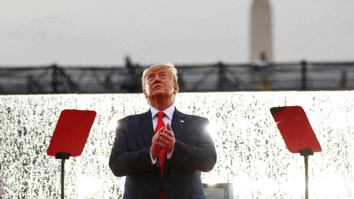 President Donald Trump looks up during the military flyovers at the Independence Day celebration in front of the Lincoln Memorial, Thursday, July 4, 2019, in Washington. The Washington Monument is in the background. (AP Photo/Carolyn Kaster)