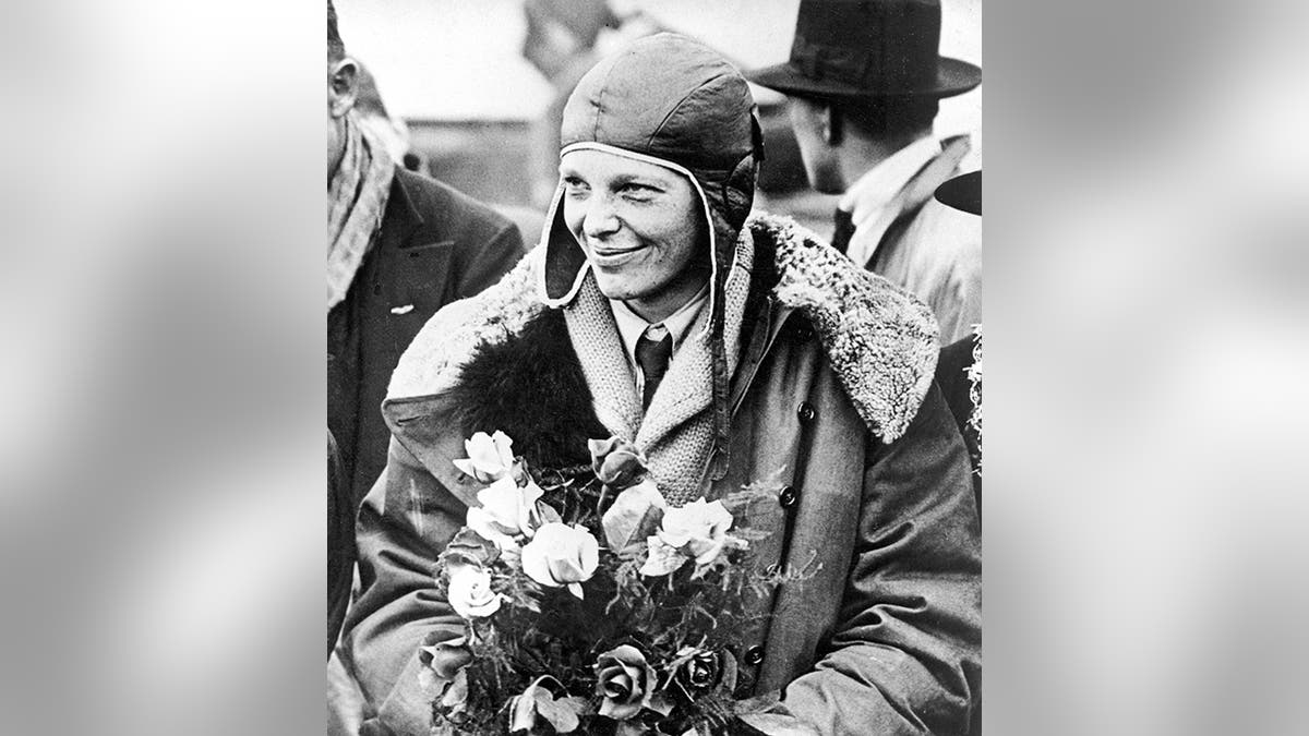 FILE - In this June 26, 1928, file photo, American aviatrix Amelia Earhart poses with flowers as she arrives in Southampton, England,  (AP Photo, File)