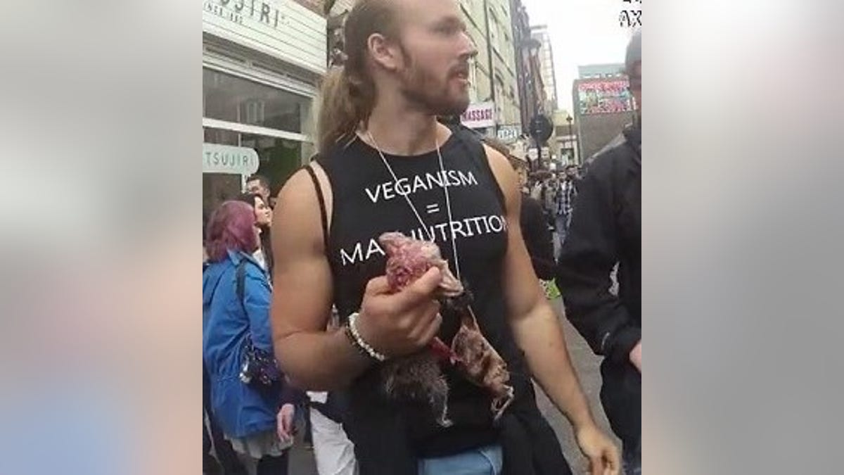 The men, one of whom is seen here, said they were staging the demonstration to bring awareness of the dangers of a meat-free diet.
