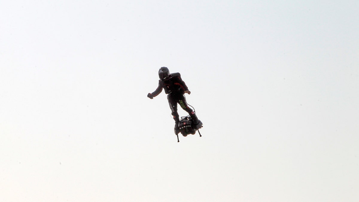 Zapata was anchored to his flyboard, a small flying platform he invented, taking off from Sangatte, in France's Pas de Calais region, and flying to the Dover area in southeast England. (AP Photo/Michel Spingler)
