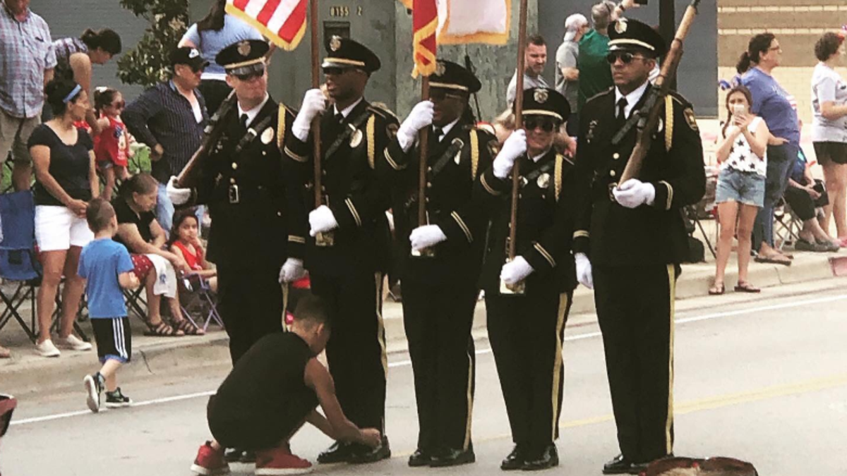 The boy – identified by police as "Josh" – ran out at the start of the parade after he noticed one of the Honor Guard members holding the American flag had his shoe untied.<br>