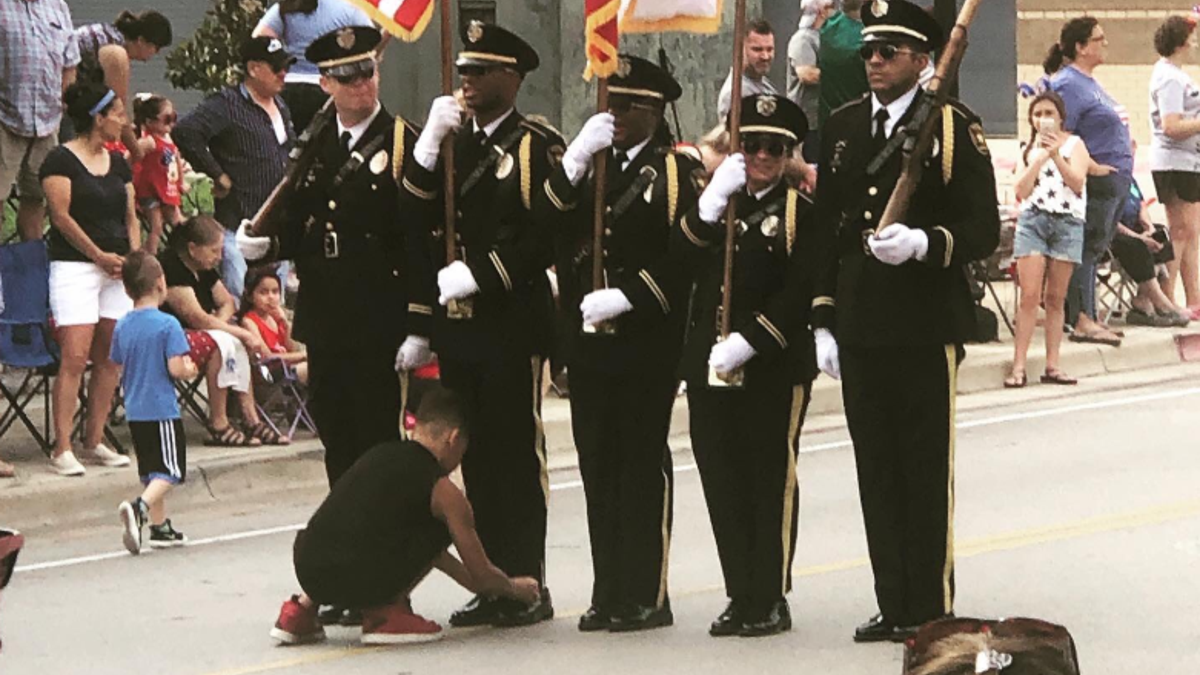 The boy – identified by police as "Josh" – ran out at the start of the parade after he noticed one of the Honor Guard members holding the American flag had his shoe untied.<br>