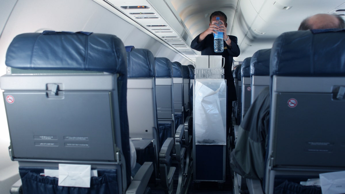 Flight attendant Kat Kamalani posted a video on TikTok explaining the grossest places on an airplane including the tray tables and seatbelt buckles. (iStock)