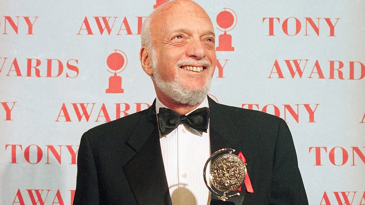 FILE - In this June 4, 1995 file photo, Harold Prince holds his Tony award for best director in a musical for 