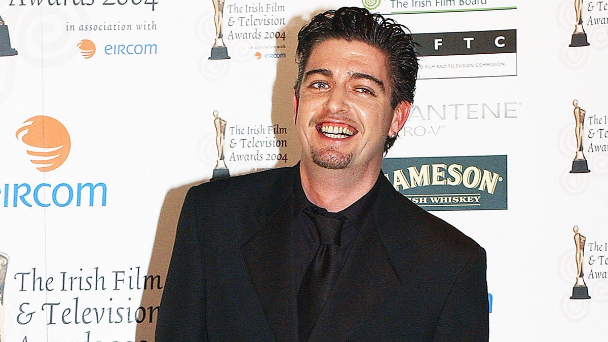 Karl Shiels attends the Irish Film and Television Awards in the Burlington Hotel on Oct. 30, 2004 in Dublin, Ireland. Shiels died in July 2019 at 47 years old. DUBLIN, IRELAND - OCTOBER 30: Karl Shiels attends the Irish Film and Television Awards in the Burlington Hotel on October 30, 2004 in Dublin, Ireland. (Photo by ShowbizIreland/Getty Images)