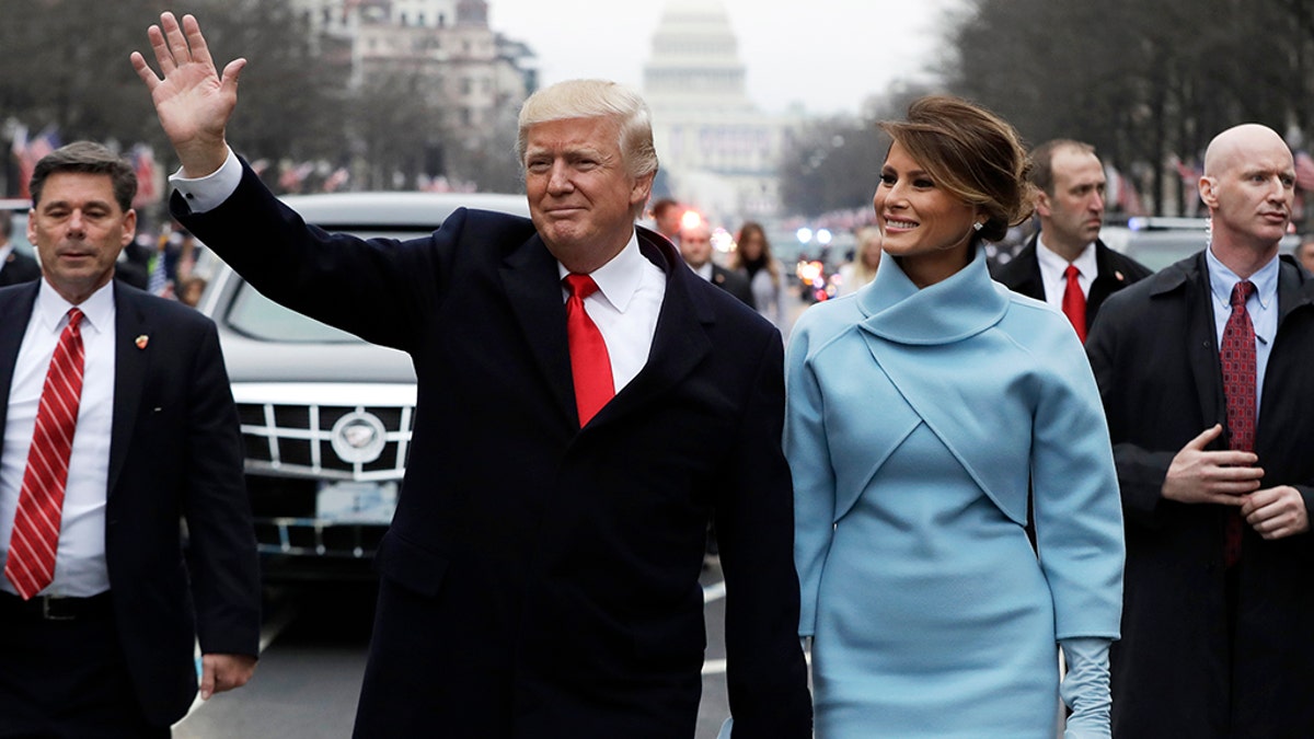 U.S. President Donald Trump and first lady Melania Trump walk during the inaugural parade from the U.S. Capitol in Washington, U.S., January 20, 2017.