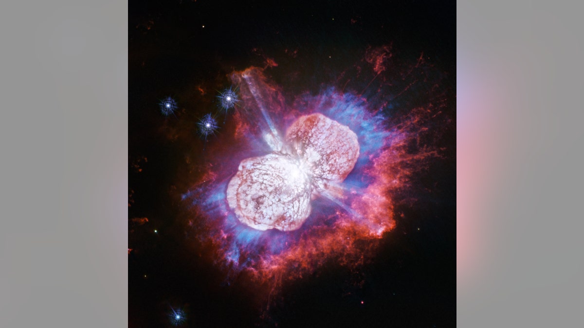 This Hubble Space Telescope image of the giant, petulant star Eta Carinae is yielding new surprises. Telescopes such as Hubble have monitored the super-massive star for more than two decades. The star, the largest member of a double-star system, has been prone to violent outbursts, including an episode in the 1840s during which ejected material formed the bipolar bubbles seen here. Now, using Hubble's Wide Field Camera 3 to probe the nebula in ultraviolet light, astronomers have uncovered the glow of magnesium embedded in warm gas (shown in blue) in places they had not seen it before. (Credit: NASA, ESA, N. Smith (University of Arizona) and J. Morse (BoldlyGo Institute))