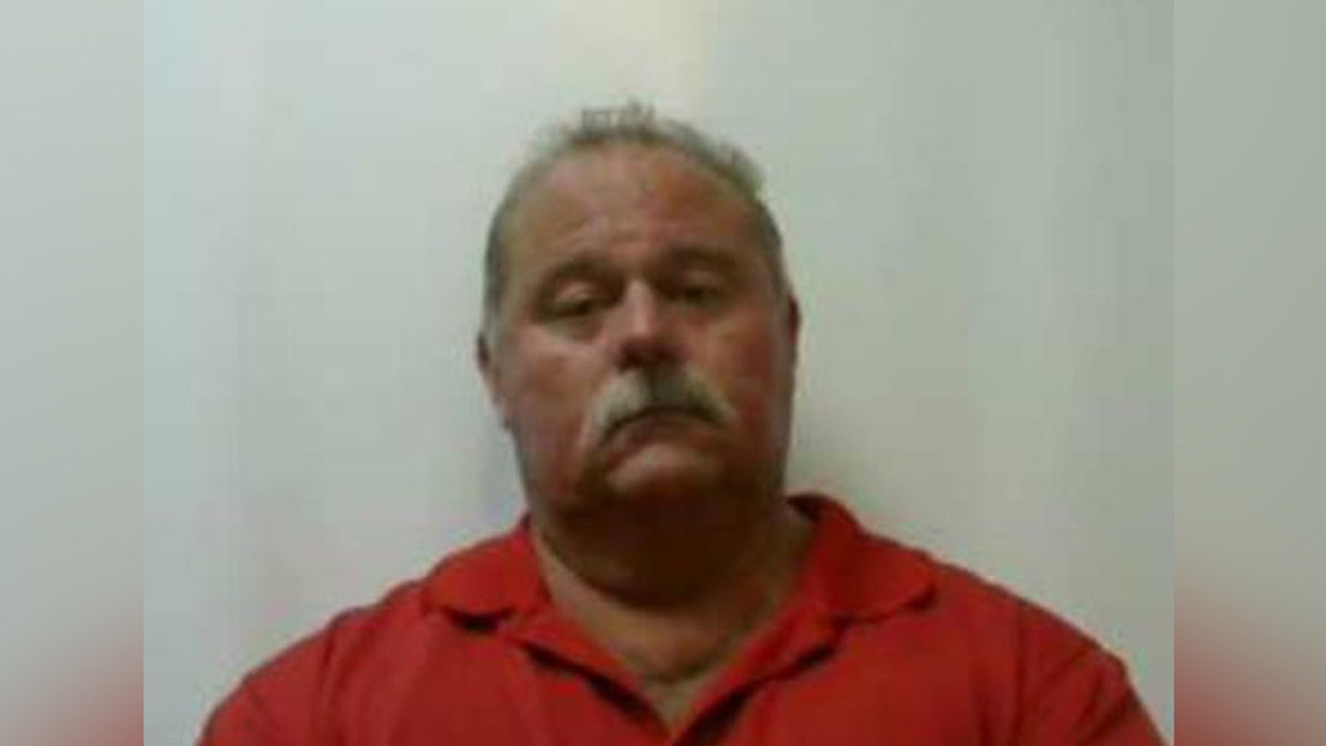 Mugshot for Peter Romans, 59, charged in Ohio with setting a fire 11 years ago that killed his wife and their two children.