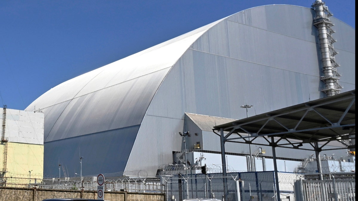 This June 1, 2019, file photo shows a view of the New Safe Confinement (NSC) movable enclosure at the nuclear power plant in Chernobyl, Ukraine. A new structure built to confine the Chernobyl nuclear reactor at the center of the world's worst nuclear disaster has been previewed for the media. (Sergei Supinsky/Pool Photo via AP, File)