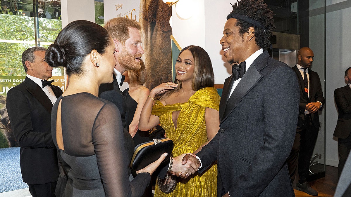 Britain's Prince Harry, Duke of Sussex (3rd L) and Britain's Meghan, Duchess of Sussex (2nd L) meet cast and crew, including US singer-songwriter Beyoncé (C) and her husband, US rapper Jay-Z (R) as they attend the European premiere of the film The Lion King in London on July 14, 2019. (Photo by Niklas HALLE'N / POOL / AFP)        (Photo credit should read NIKLAS HALLE'N/AFP/Getty Images)