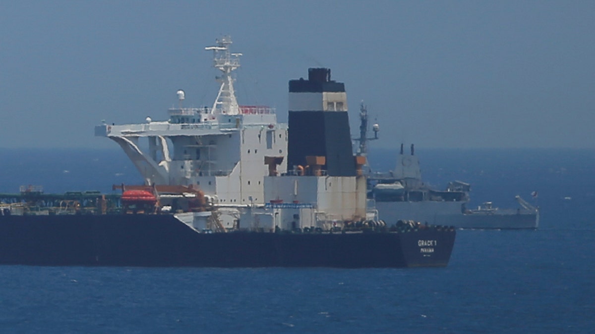 A British Royal Navy patrol vessel guards the oil supertanker Grace 1.