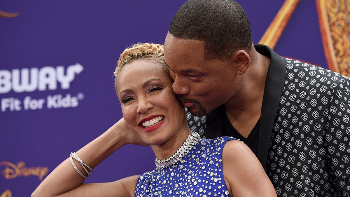 Will Smith, right, kisses Jada Pinkett Smith as they arrive at the premiere of "Aladdin" at the El Capitan Theatre on May 21, 2019, in Los Angeles, Calif. (Photo by Chris Pizzello/Invision/AP, File)