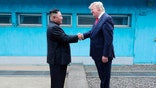 In this Sunday, June 30, 2019, photo provided by the North Korean government, North Korean leader Kim Jong Un, left, and U.S. President Donald Trump shake hands over the military demarcation line at the border village of Panmunjom in Demilitarized Zone. The content of this image is as provided and cannot be independently verified. Korean language watermark on image as provided by source reads: "KCNA" which is the abbreviation for Korean Central News Agency. (Korean Central News Agency/Korea News Service via AP)