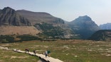 File - This Sept. 4, 2017, file photo, shows hikers on the Hidden Lake trail in Glacier National Park in Montana. Wildlife officials are asking people who are traveling near Glacier National Park to report sightings of animals crossing the road. The Missoulian reported Monday, July 22, 2019, that park officials and the U.S. Geological Survey want to know where animals are crossing U.S. Highway 2. (AP Photo/Beth J. Harpaz, File)