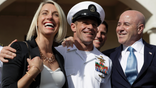 Navy Special Operations Chief Edward Gallagher, center, walks with his wife, Andrea Gallagher, left, and advisor, Bernard Kerik as they leave a military court on Naval Base San Diego, Tuesday, July 2, 2019, in San Diego. A military jury acquitted the decorated Navy SEAL Tuesday of murder in the killing of a wounded Islamic State captive under his care in Iraq in 2017. (AP Photo/Gregory Bull)