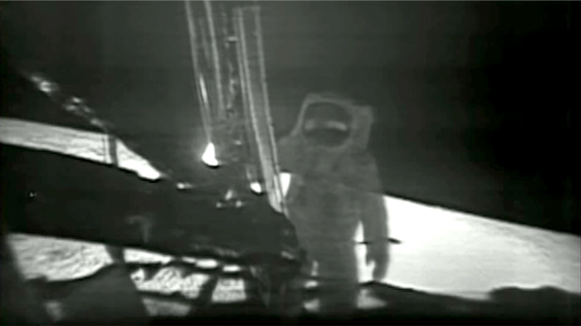 Astronaut Neil Armstrong steps off the lunar module to become the first person to walk on the moon.