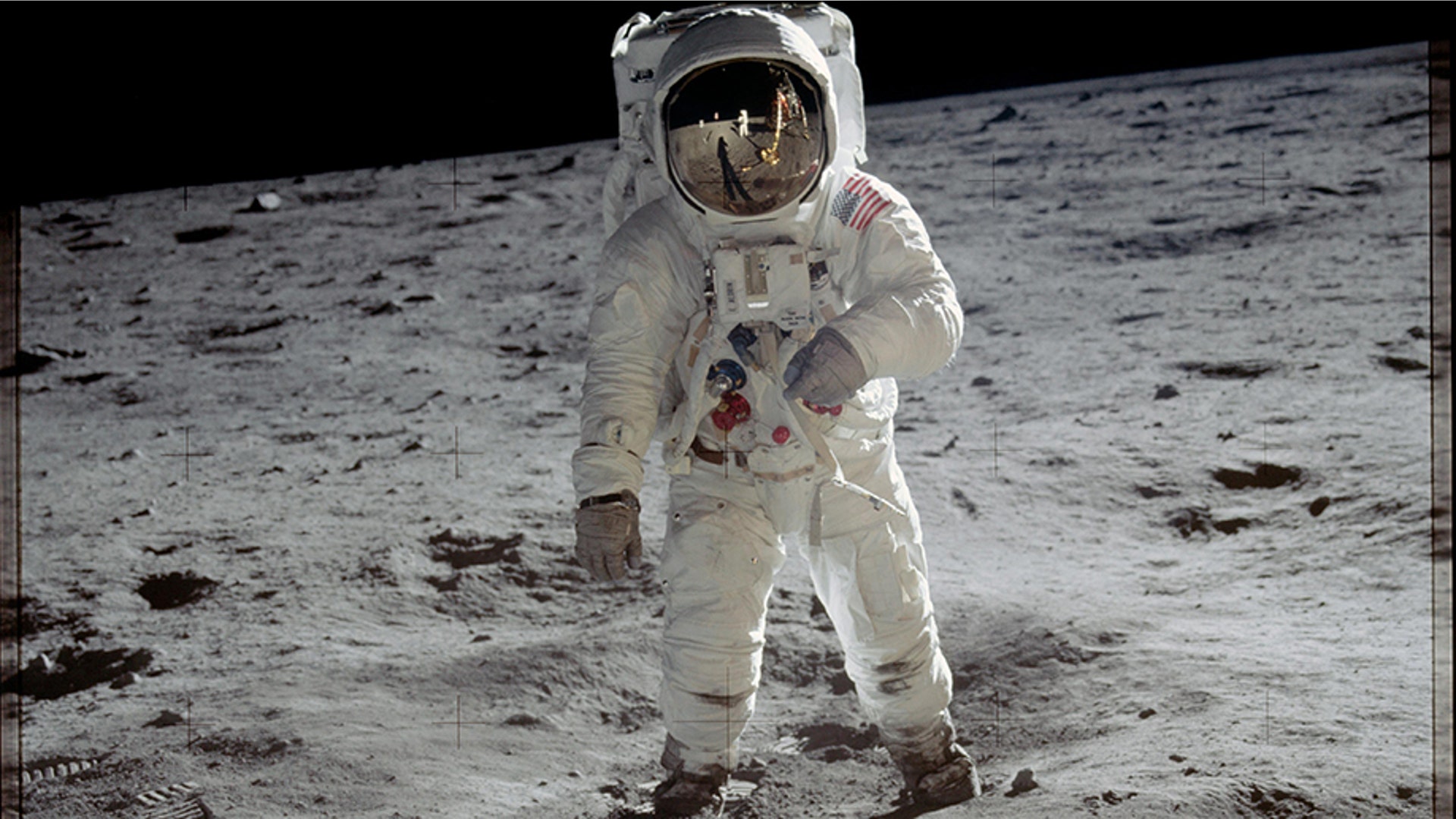 Astronaut Buzz Aldrin walks on the surface of the moon during the Apollo 11 mission. Mission commander Neil Armstrong took this photograph with a 70mm lunar surface camera. 
