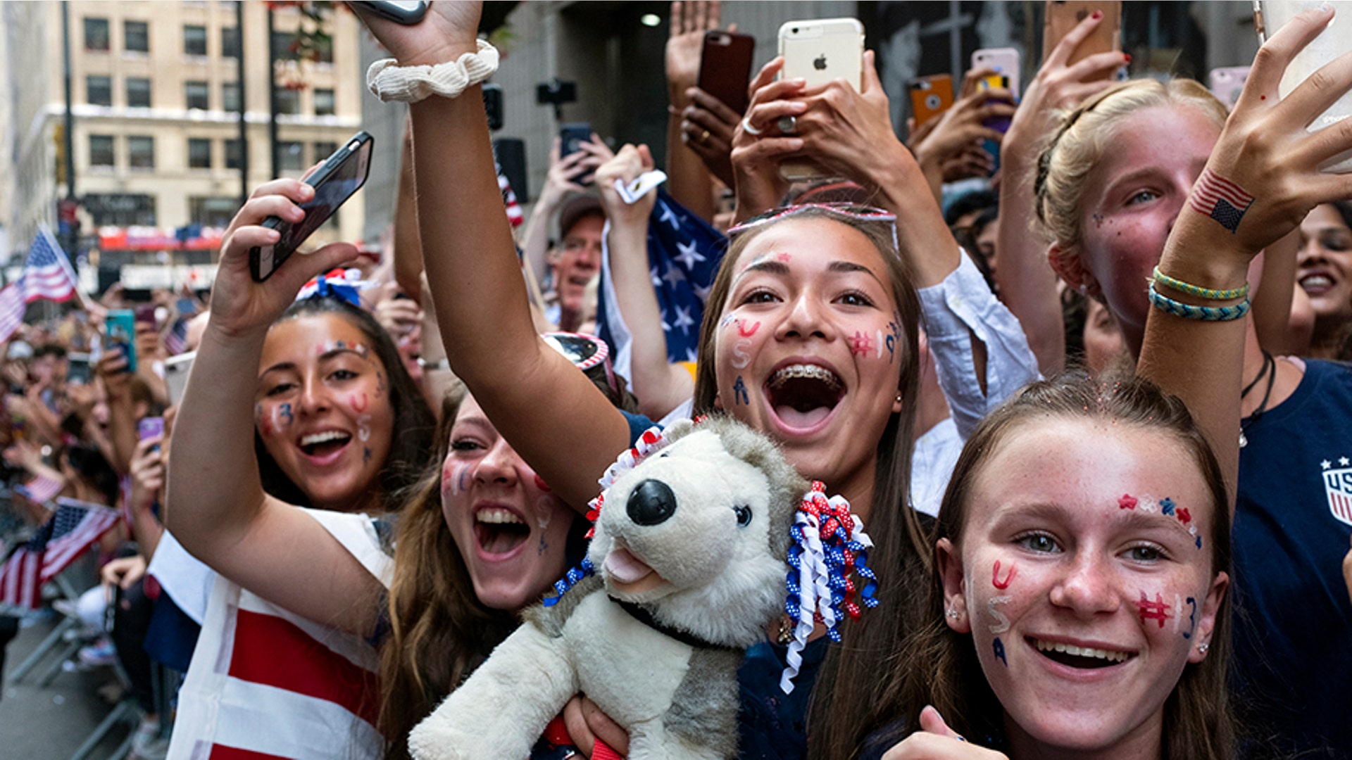 Fans celebrates as members of the U.S. women's soccer team pass by during a ticker-tape parade in New York City, July 10, 2019.