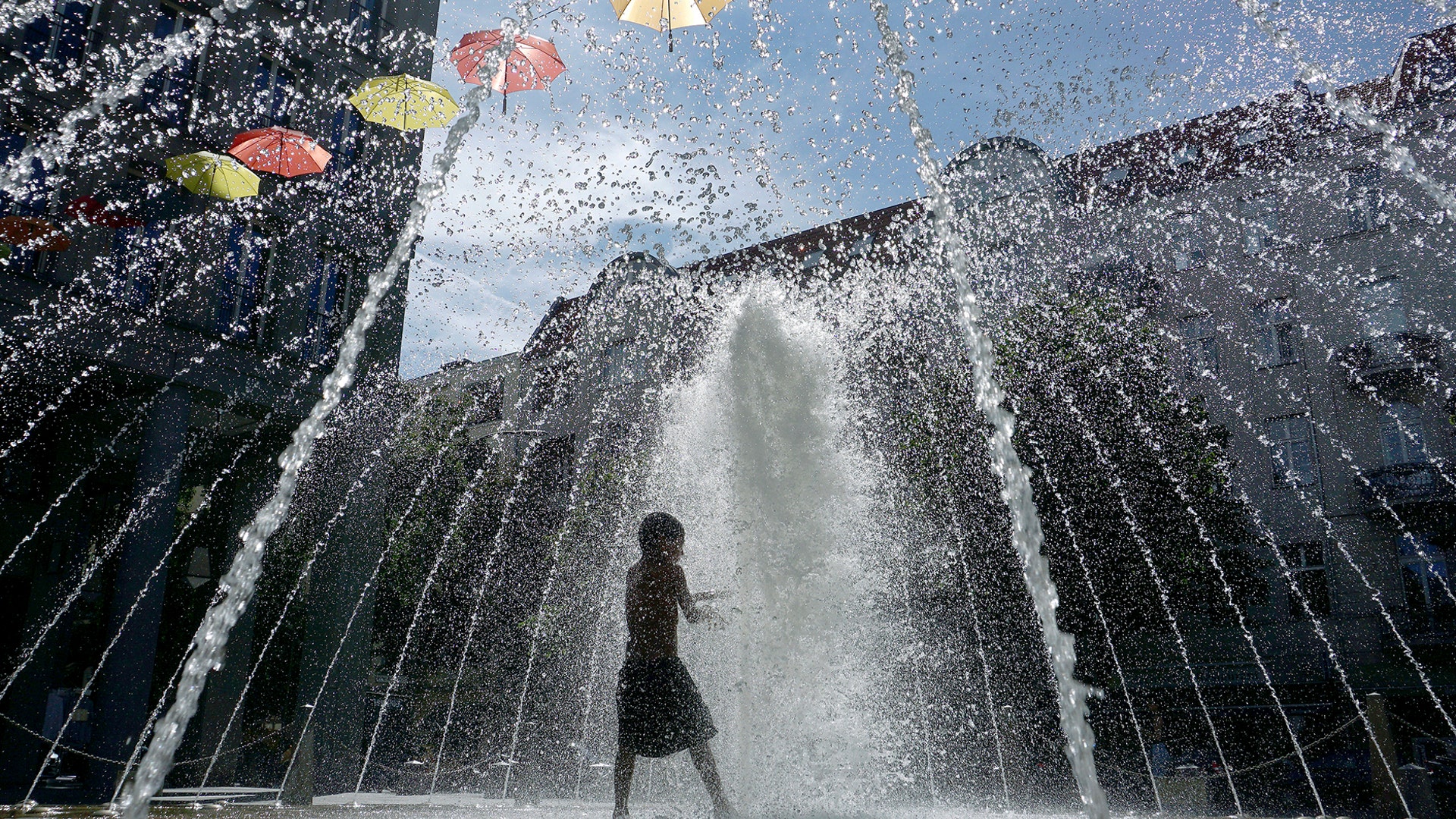 A boy plays in a fountain in Berlin, Germany, July 24, 2019. 