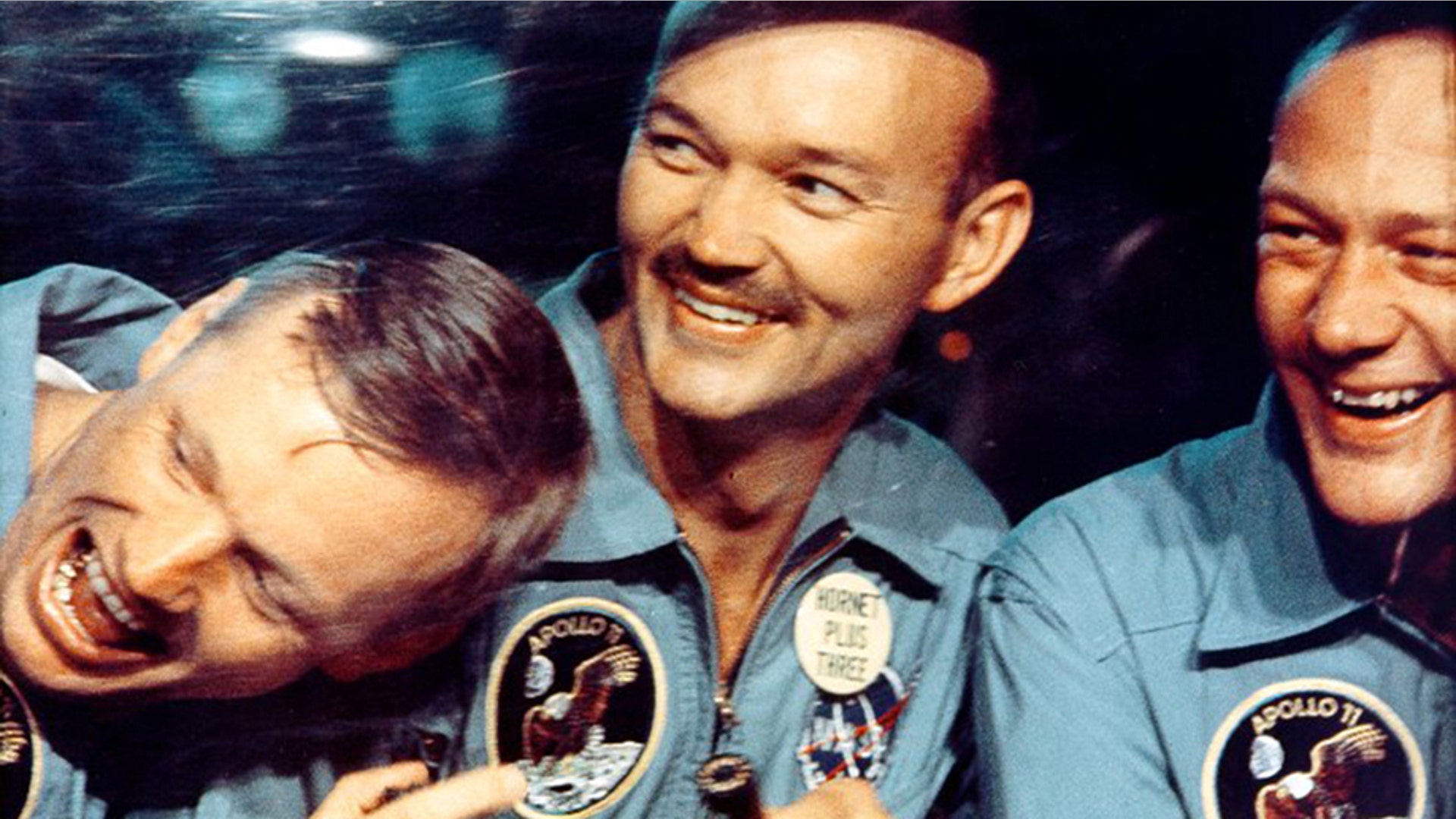 Astronauts Commander Neil Armstrong, Command Module Pilot Michael Collins and Lunar Module Pilot Buzz Aldrin in the Mobile Quarantine Facility after splashdown in the Pacific Ocean, July 24, 1969.