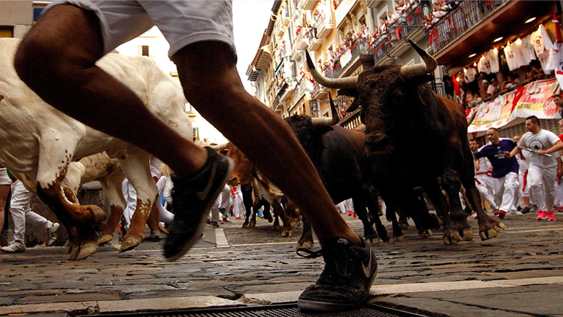 Revelers run next to bulls from the Cebada Gago ranch, during the running of the bulls at the San Fermin Festival, in Pamplona, Spain, July 8, 2019. 