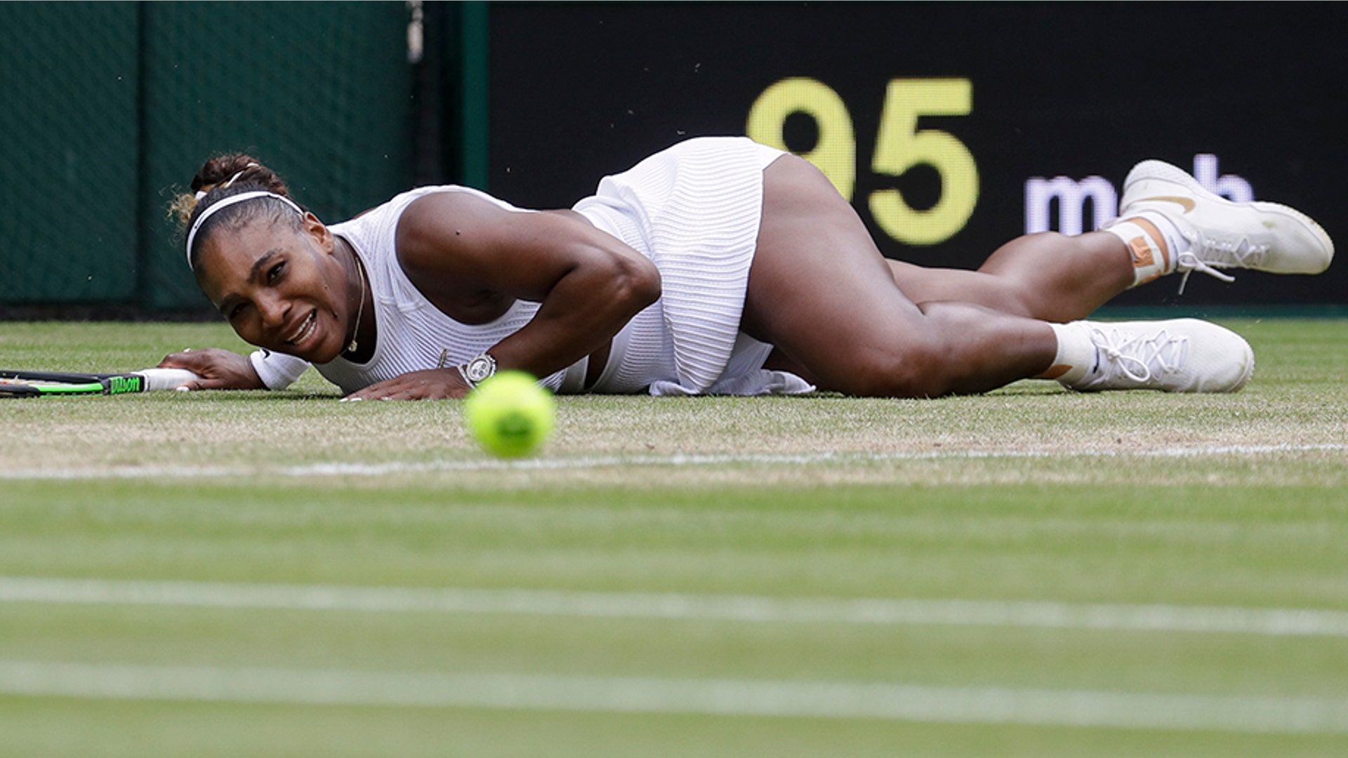 Serena Williams of the U.S. falls attempting to return the ball to Alison Riske during a women's quarterfinal match at the Wimbledon Tennis Championships in London, July 9, 2019. (AP Photo/Kirsty Wigglesworth)