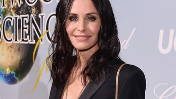 Courteney Cox stuns in little black bikini while 'diving' into her next year of life