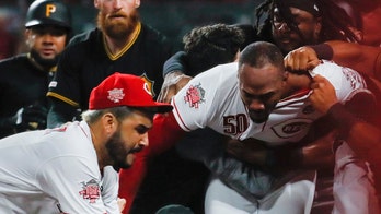 Cincinnati Reds' Amir Garrett appears to try and fight the entire Pittsburgh Pirates dugout
