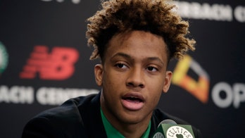 Boston Celtics' Romeo Langford seen shooting with ping-pong paddle taped to hand