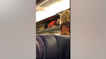Southwest Airlines flight attendant inside overhead compartment 'perplexes' passenger