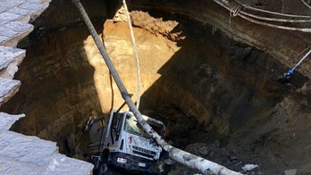 Garbage truck falls into massive sink hole in Italian city, sparking evacuations