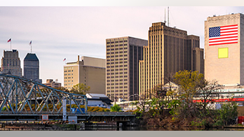 SEE IT: Man in suit piggy-backs woman to escape flooded New Jersey train station